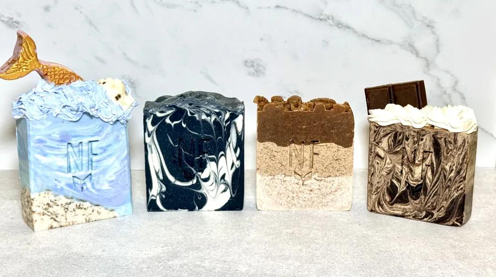 Four NovaFusion bars standing side by side on a marble counter, each stamped with the NF mark.